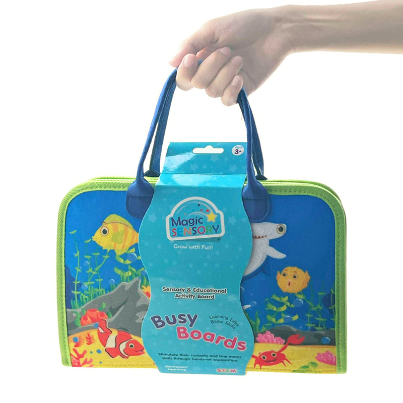Load image into Gallery viewer, Busy Board folded shut with carry handles, showing under-the-sea themed cover design
