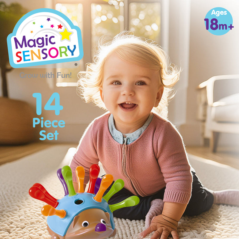Load image into Gallery viewer, Smiling toddler sitting on a rug near the Echidna Sorting Toy with 14 piece set labelled
